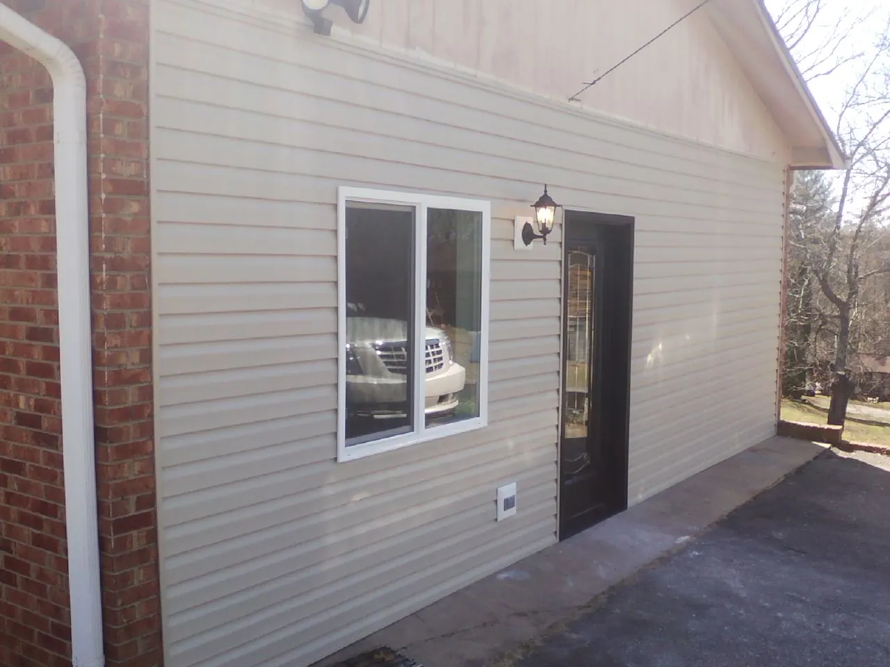 New vinyl siding and entry door on a room addition in Woodbury
